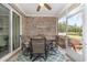 Screened porch with ceiling fan, brick walls and outdoor seating at 349 N Bar Ct., Myrtle Beach, SC 29579