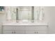 Bathroom featuring a double sink vanity with modern fixtures, clean white countertops, and a large mirror at 378 Ladyfish Loop, Sunset Beach, NC 28468