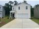 Charming two-story home with a classic white exterior, complemented by a well-maintained lawn and a spacious driveway at 378 Ladyfish Loop, Sunset Beach, NC 28468