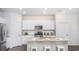 Modern kitchen featuring white cabinets, stainless steel appliances, granite countertops, and an island with barstool seating at 378 Ladyfish Loop, Sunset Beach, NC 28468