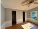 Bedroom with two closet doors, paneled lower walls, and a window with sunlight streaming in at 3802 Stern Dr., Conway, SC 29526
