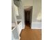 Hallway view with laminate flooring, neutral wall paint, and limited natural light at 3802 Stern Dr., Conway, SC 29526