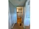 A view down the hallway to a storage area with laminate flooring and built-in shelving at 3802 Stern Dr., Conway, SC 29526