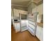 Image shows a white refrigerator, microwave, and cabinets within a mobile home’s kitchen at 3802 Stern Dr., Conway, SC 29526