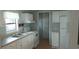 The house’s kitchen features white cabinetry and appliances set against light blue walls and traditional countertops at 3802 Stern Dr., Conway, SC 29526