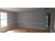 Bright living room with neutral paint, wood floors, and large window perfect for relaxing or entertaining guests at 3802 Stern Dr., Conway, SC 29526