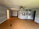 A wide shot of the home’s living room and kitchen, showing a hardwood floor, gray walls and white ceiling at 3802 Stern Dr., Conway, SC 29526