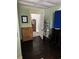 Bedroom featuring dark wood floors, a dresser, a shoe rack, a television, and a glimpse into the next room at 402 Gibson St., Marion, SC 29571