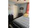 A cozy bedroom with blue walls, striped bedding, and a dark wood dresser showcasing decorative items at 402 Gibson St., Marion, SC 29571