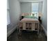 Sunlit bedroom with simple decor featuring a bed with two lamps, windows, and refinished wood floors at 402 Gibson St., Marion, SC 29571