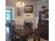 Dining room with a dark wood table, chairs, a chandelier, and a cabinet with glass doors at 402 Gibson St., Marion, SC 29571