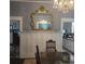 Dining room featuring a large gilded mirror, a crystal chandelier, and views into adjoining rooms at 402 Gibson St., Marion, SC 29571