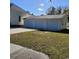 Exterior view of a detached three-car garage with a concrete driveway and green grass at 402 Gibson St., Marion, SC 29571
