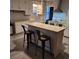 Well-lit kitchen featuring an island with bar seating, white cabinets, and modern appliances at 402 Gibson St., Marion, SC 29571