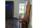 Living room featuring a TV on a dresser, a work desk, a chair, and an exterior door leading to the outdoors at 402 Gibson St., Marion, SC 29571