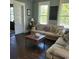 Inviting living area with dark stained wood flooring, comfortable seating, and natural light from the windows at 402 Gibson St., Marion, SC 29571