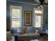 Comfortable living room with natural light from two windows, complemented by a loveseat and neutral decor at 402 Gibson St., Marion, SC 29571