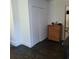 Room featuring a closet with sliding doors, a wooden dresser, dark-stained floors, and white trim at 402 Gibson St., Marion, SC 29571