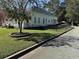 A side view of the property showcasing well-maintained lawn with street view at 402 Gibson St., Marion, SC 29571