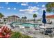 Inviting community pool area with lounge chairs, tables and umbrellas with a marina view at 4215 Coquina Harbour Dr. # D -2, Little River, SC 29566