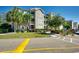 Exterior of condominium building featuring balconies, beautiful landscaping, and reserved parking spaces at 4215 Coquina Harbour Dr. # D -2, Little River, SC 29566