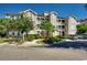 Exterior view of a well-maintained condominium complex with lush landscaping and convenient parking at 4215 Coquina Harbour Dr. # D -2, Little River, SC 29566