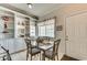 Cozy dining area featuring a glass-top table, comfortable seating, and built-in shelving with decor at 4215 Coquina Harbour Dr. # D -2, Little River, SC 29566