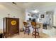Kitchen bar area with stools, and a glimpse of the kitchen featuring white cabinets and stainless appliances at 4215 Coquina Harbour Dr. # D -2, Little River, SC 29566