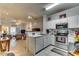 Open concept kitchen showcasing stainless steel appliances, ample counter space, and an adjacent living area at 4215 Coquina Harbour Dr. # D -2, Little River, SC 29566