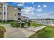 Community outdoor grill area with marina view, lush grass, and building at 4215 Coquina Harbour Dr. # D -2, Little River, SC 29566