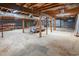 Unfinished basement showcasing exposed beams, concrete floor, and ample space for storage or future customization at 4546 River Rd., Little River, SC 29566
