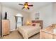 Cozy bedroom with ceiling fan, natural wood furniture, and soft lighting at 4709 Wild Iris Dr. # 101, Myrtle Beach, SC 29577
