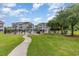 Well-maintained community grounds with lush lawn, picnic area, and community pool at 4709 Wild Iris Dr. # 101, Myrtle Beach, SC 29577