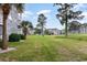 Scenic view of community buildings surrounded by a lush green lawn and mature trees at 4709 Wild Iris Dr. # 101, Myrtle Beach, SC 29577