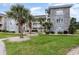Attractive condo building featuring stone accents, multiple balconies, and well-kept landscaping at 4709 Wild Iris Dr. # 101, Myrtle Beach, SC 29577