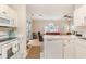 Bright, open kitchen overlooking the living room with modern appliances and breakfast bar at 4709 Wild Iris Dr. # 101, Myrtle Beach, SC 29577