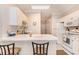 Charming kitchen with white cabinets, breakfast bar, and access to other rooms at 4709 Wild Iris Dr. # 101, Myrtle Beach, SC 29577