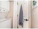 Practical laundry area with stacked washer and dryer, towel hook, and wall art at 4709 Wild Iris Dr. # 101, Myrtle Beach, SC 29577