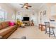 Inviting living room with comfortable seating, ceiling fan and view of breakfast bar at 4709 Wild Iris Dr. # 101, Myrtle Beach, SC 29577
