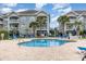 Community pool with lounge chairs and palm trees offers a relaxing outdoor space at 4709 Wild Iris Dr. # 101, Myrtle Beach, SC 29577