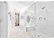 All white bathroom with a soaking tub under an oval window and a walk-in shower at 486 Lantana Circle, Georgetown, SC 29440