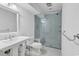 Elegant all-white bathroom featuring a glass enclosed walk-in shower with a built-in bench at 486 Lantana Circle, Georgetown, SC 29440