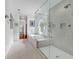 Spacious bathroom featuring a glass-enclosed shower and separate tub with a unique circular window at 486 Lantana Circle, Georgetown, SC 29440