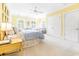 Bedroom with a light yellow wall, white carpet, a ceiling fan, and lots of natural light at 486 Lantana Circle, Georgetown, SC 29440