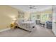 Comfortable bedroom with a ceiling fan, two windows, and a sitting area for relaxation at 486 Lantana Circle, Georgetown, SC 29440