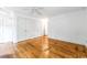Bright bedroom features hardwood floors, ceiling fan, and closet doors at 486 Lantana Circle, Georgetown, SC 29440