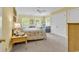Comfortable bedroom with a ceiling fan, two windows, and a sitting area for relaxation at 486 Lantana Circle, Georgetown, SC 29440
