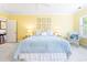Bedroom with yellow walls, white carpet, a ceiling fan, and natural light from a window at 486 Lantana Circle, Georgetown, SC 29440