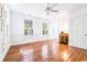 Bedroom featuring hardwood floors, two windows, neutral walls, and white trim at 486 Lantana Circle, Georgetown, SC 29440