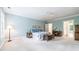 Bright bedroom with light blue walls, white trim, ceiling fan, and carpet at 486 Lantana Circle, Georgetown, SC 29440